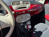 dashboard of a small car with a steering wheel and dashboard controls