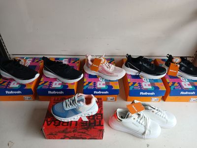several pairs of tennis shoes are lined up on a box