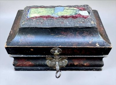 a small wooden box with a painting on it