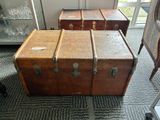 three trunks sitting on the floor in a room