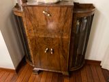 a wooden cabinet with a mirror on top of it