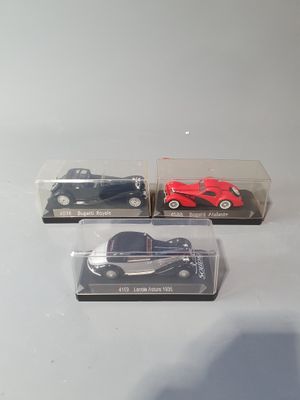 three toy cars that are sitting in a display case