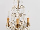 a small crystal chandelier with three candles on it