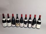 six bottles of wine lined up in a row on a table