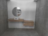 a bathroom with a sink and a mirror in it