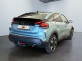 the rear end of a blue car parked in a garage