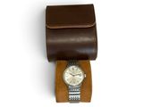 brown leather watch case with a watch on top of it