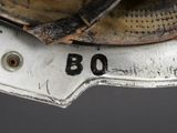 a close up of a baseball glove on top of a baseball bat