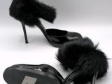black high heeled shoes with fur on the toes on a white background