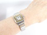 a woman ' s wrist that has a watch on it
