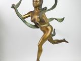 bronze statue of a woman holding a ribbon in her hand