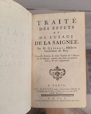 an old book that is open on a table