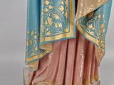 an image of a statue of a woman in a blue and gold dress