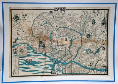 an old map of the city of tokyo with a blue border around it