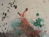 painting on the wall of a room with paint splatters all over it