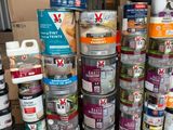 many cans of paint stacked on top of each other