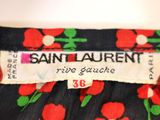 a close up of a label on a dress with red flowers on it