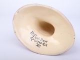a white vase with a black writing on it
