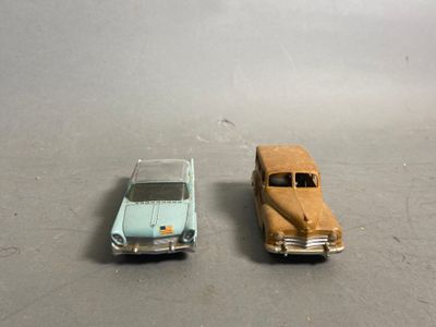 two toy cars sitting next to each other on a table