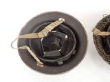 two different types of helmets on a white surface