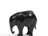 a small black elephant that is standing on a white surface