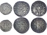 six ancient roman coins, one of which has a cross on it