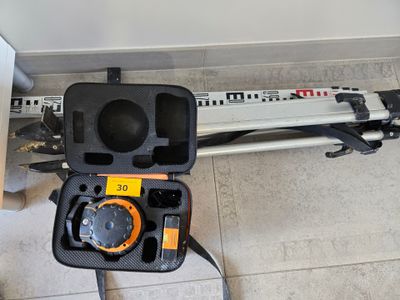 a tool in a case on the floor next to a wall