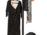an image of a coat rack with clothes on it and a hat on a stand