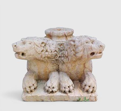 a statue of a group of animals that are sitting on the ground
