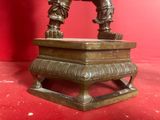 a bronze statue of a man on top of a box