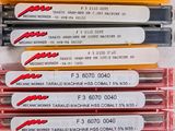 several different types of pens are lined up on a table