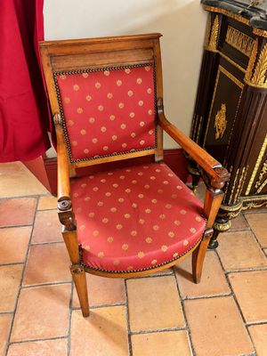 une chaise qui se trouve dans une pièce, à côté d'une armoire