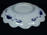 a blue and white bowl with a flower design on it