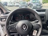 a steering wheel and dashboard of a car in a parking lot