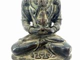 statue of a person sitting in a lotus position on a white background