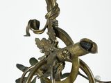 a chandelier that has a bird on top of it