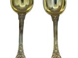 pair of silver spoons on a white background with a white background