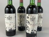 four bottles of wine are lined up on a table