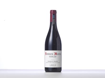 a bottle of red wine sitting on top of a counter