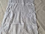 a white table runner on a table with a white table cloth
