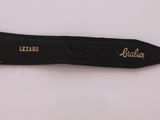 a close up of a knife with a black handle on a white surface