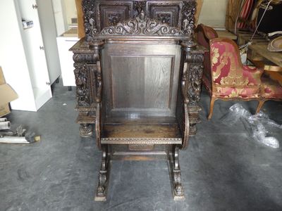 a wooden chair that is sitting in the middle of a room