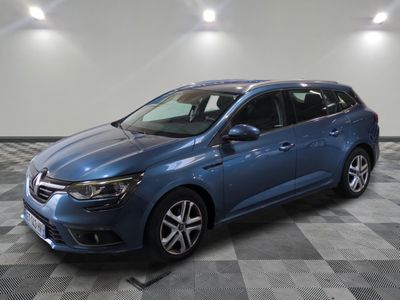 a blue car parked in a garage with a checkered floor
