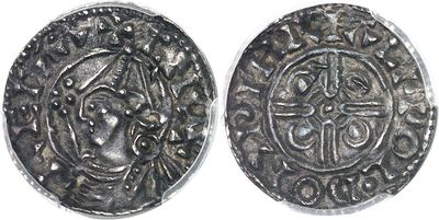 a close up of a coin with a cross on it