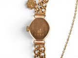 an image of a close up of a wrist watch on a chain