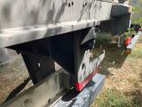 a close up of a flatbed truck that is parked in the grass