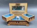 a small wooden box with a ballerina in it