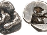 silver coin with image of a woman and a cat on it