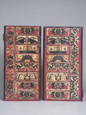 these are two wooden boxes with designs on them sitting on a table