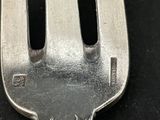 a fork that has two black handles on it
